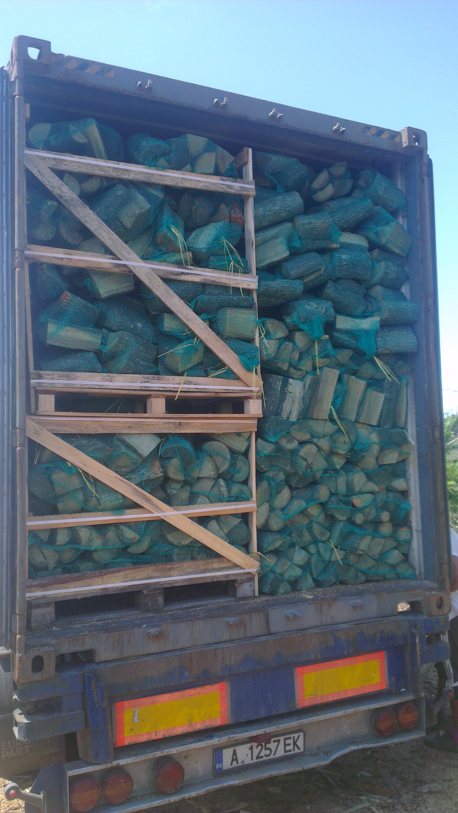 firewood hardwood in net bags on pallet boxes